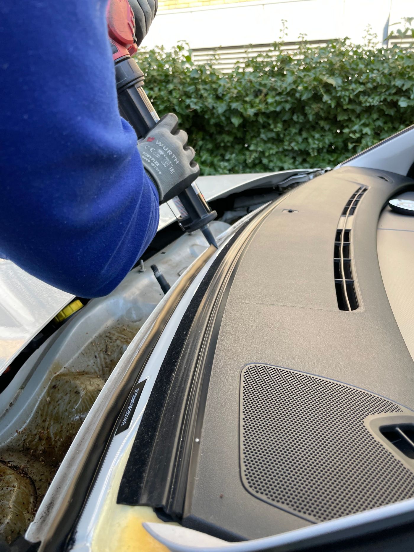 Mobile windshield installation — technician sealing the pinch weld on-site